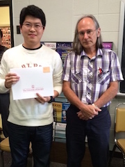 Jun Zhang receiving award from Malcolm Adams